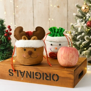 Christmas burlap drawstring gift bags with 3D reindeer and snowman designs on wood