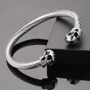 Silver twisted wire stainless steel skull bracelet with a C-shape open cuff design