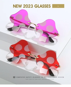 Detail of mushroom shaped rimless sunglasses with red lenses and white polka dots