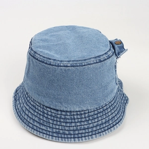 Detailed view of light blue denim bucket hat with side copper buckle and reinforced stitching