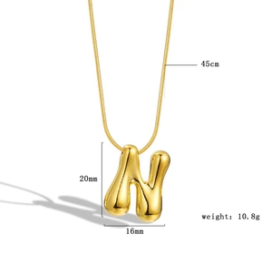 Macro shot of 18k gold plated bubble letter N pendant with size and weight dimensions