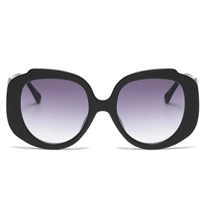 Fashionable oversized round sunglasses with black frames and purple gradient lenses