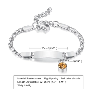 Macro view of stainless steel ID bracelet with curved engravable plate and orange stone