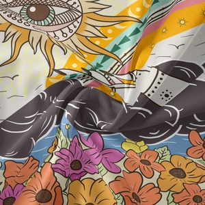 Detailed view of bohemian tapestry fabric showing sun and floral print textures