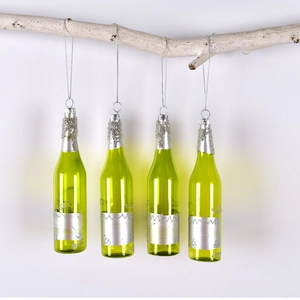 Christmas green glass wine bottle ornaments with silver glitter hanging on white branch