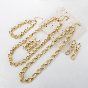 Detail of gold hip hop jewelry set with chunky twisted oval links and matching earrings