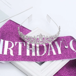 Detail of silver rhinestone crown and purple glitter Birthday Queen sash with safety pin