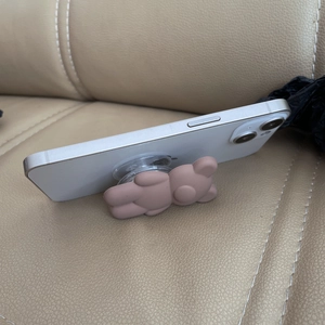 Cute pink-brown matte bear pop socket foldable grip for smartphones shown in side view