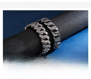 Macro view of retro engraved stainless steel Cuban chain bracelet on display