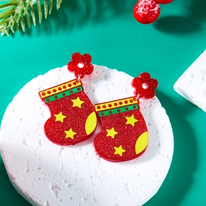 Detailed view of red Christmas stocking acrylic earrings with glitter and star patterns