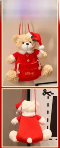 Detail of Christmas teddy bear plush bag with red outfit and Merry Christmas embroidery