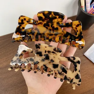 Large tortoiseshell acetate hair claws in dark leopard and beige patterns for thick hair