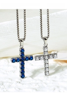Detailed macro view of titanium steel cross necklace with blue and white cubic zirconia