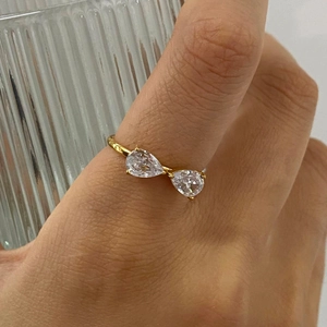 Close-up of adjustable gold-plated stainless steel ring with dual pear-cut cubic zirconia stones