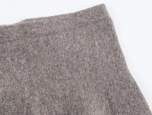 Close-up of premium grey knit fabric texture and high-quality seam stitching on the skirt