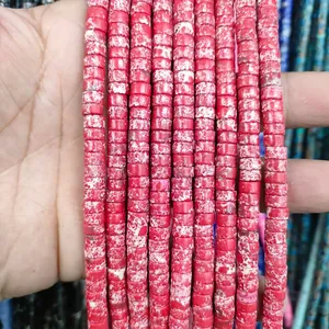 Close-up of natural red stone spacer beads with unique mottled textures for DIY jewelry