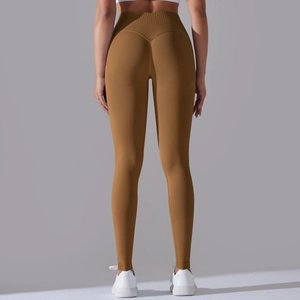 Detail of high-waist seamless leggings showing V-shaped peach lift stitching in caramel