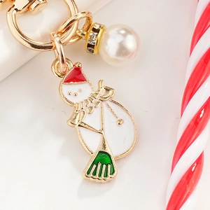 Cartoon Christmas snowman keychain with gold metal ring, white enamel, and pearl accents