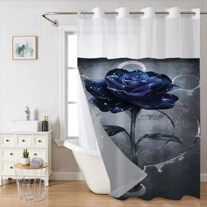 Detail of waffle weave shower curtain with blue rose print and silver circular motifs