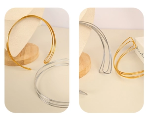 Detail of minimalist multi-layered gold and silver choker necklaces in C-shape design