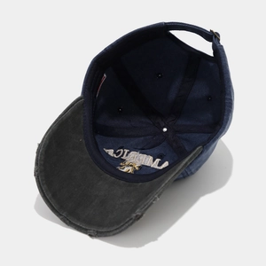 Detail showing the inner AMERICA embroidery and vintage distressed brim of the baseball cap