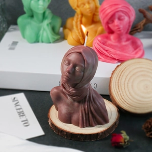 Detail of female bust silicone candle molds in various colors on a rustic wooden base