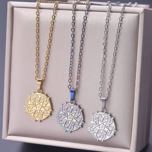 Detailed view of three pentagram and snake charms in gold, silver and iridescent finish