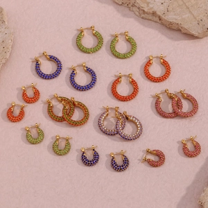 Detail of gold hoop earrings with multi-colored zircons in various sizes and vibrant hues