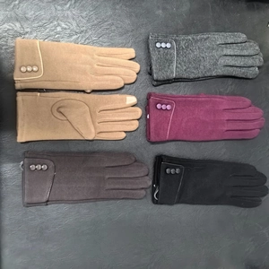 Close-up of winter warm fleece gloves for women in various colors with decorative buttons