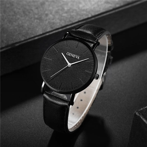 Detail of Geneva quartz watch with black textured dial and matching leather strap