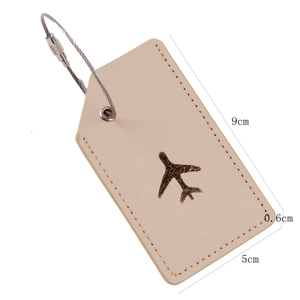 Detailed view of beige leather luggage tag with steel cable and plane logo dimensions