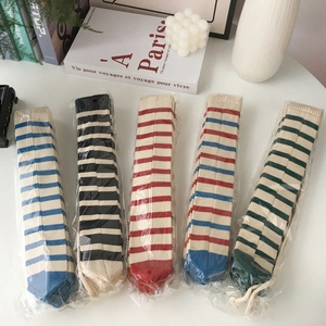 Detail showing five pairs of colorful striped cotton socks in individual packaging
