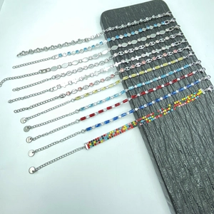 S.Steel minimalist bracelets with colorful zircon crystals on black stone background