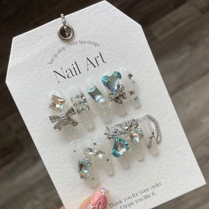 White wedding press-on nails with heart rhinestones and silver bow decorations