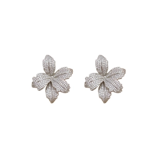 Symmetric silver flower stud earrings set with white cubic zirconia floral pattern