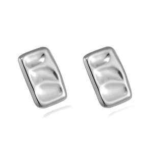 Macro view of silver irregular hammered metal stud earrings with textured finish