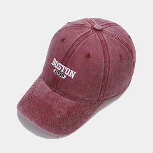 Close-up of maroon washed cotton baseball cap featuring white Boston 1630 embroidery