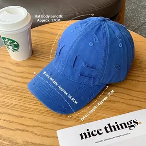 Distressed bright blue baseball cap on wooden table with detailed dimensions and vintage look