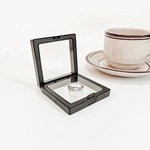 Detail of a silver diamond ring suspended in a black anti-oxidation PE film display box