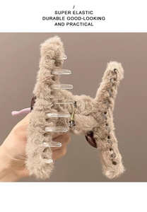 Detail of light brown plush hair claw clip showing durable metal spring and soft texture