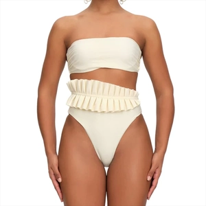 Detail of cream white high waisted bikini with elegant ruffles and ruched texture fabric