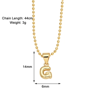Detail showing the polished golden letter G pendant necklace with 44cm chain length