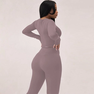 Detail of high-elasticity knitted fabric on mauve slim-fit yoga and fitness set