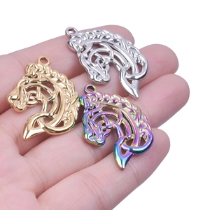 Detailed view of three horse head charms in gold silver and rainbow finishes