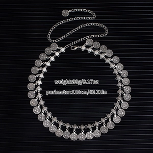 Close-up of bohemian metal waist chain with vintage coin charms and size markings