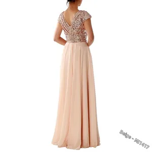 Detail of sequined back and elegant chiffon skirt on long beige evening gown