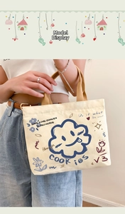 Canvas tote bag detail showing cartoon graphics and Have Some Cookies print