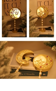 Detailed view of golden moon and star LED lamp with warm yellow ambient glow