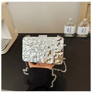 Silver evening clutch bag featuring a ripple texture metal frame and delicate chain strap
