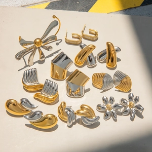 Two-tone stainless steel jewelry set featuring gold and silver flower brooch and earrings